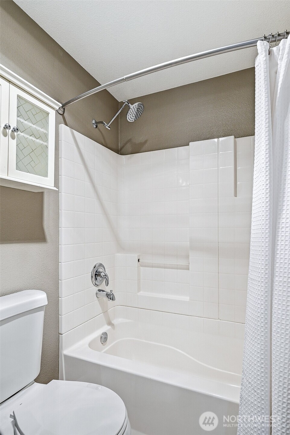 3045 20th Avenue West, Unit 409 Seattle, WA 98199 - Photo 15 of 25 a bathroom with a toilet and a shower