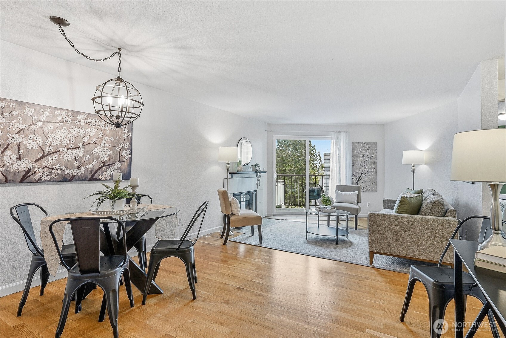 3045 20th Avenue West, Unit 409 Seattle, WA 98199 - Photo 3 of 25 a view of a dining room with furniture wooden floor and chandelier