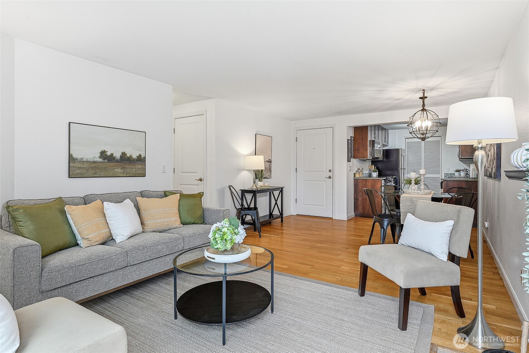 3045 20th Avenue West, Unit 409 Seattle, WA 98199 - Photo 6 of 25 a living room with furniture kitchen view and a table