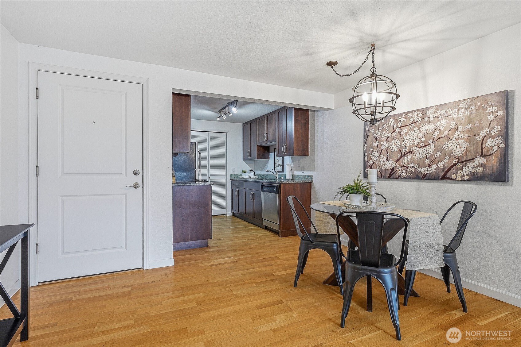 3045 20th Avenue West, Unit 409 Seattle, WA 98199 - Photo 7 of 25 a view of a dining room with furniture and a chandelier