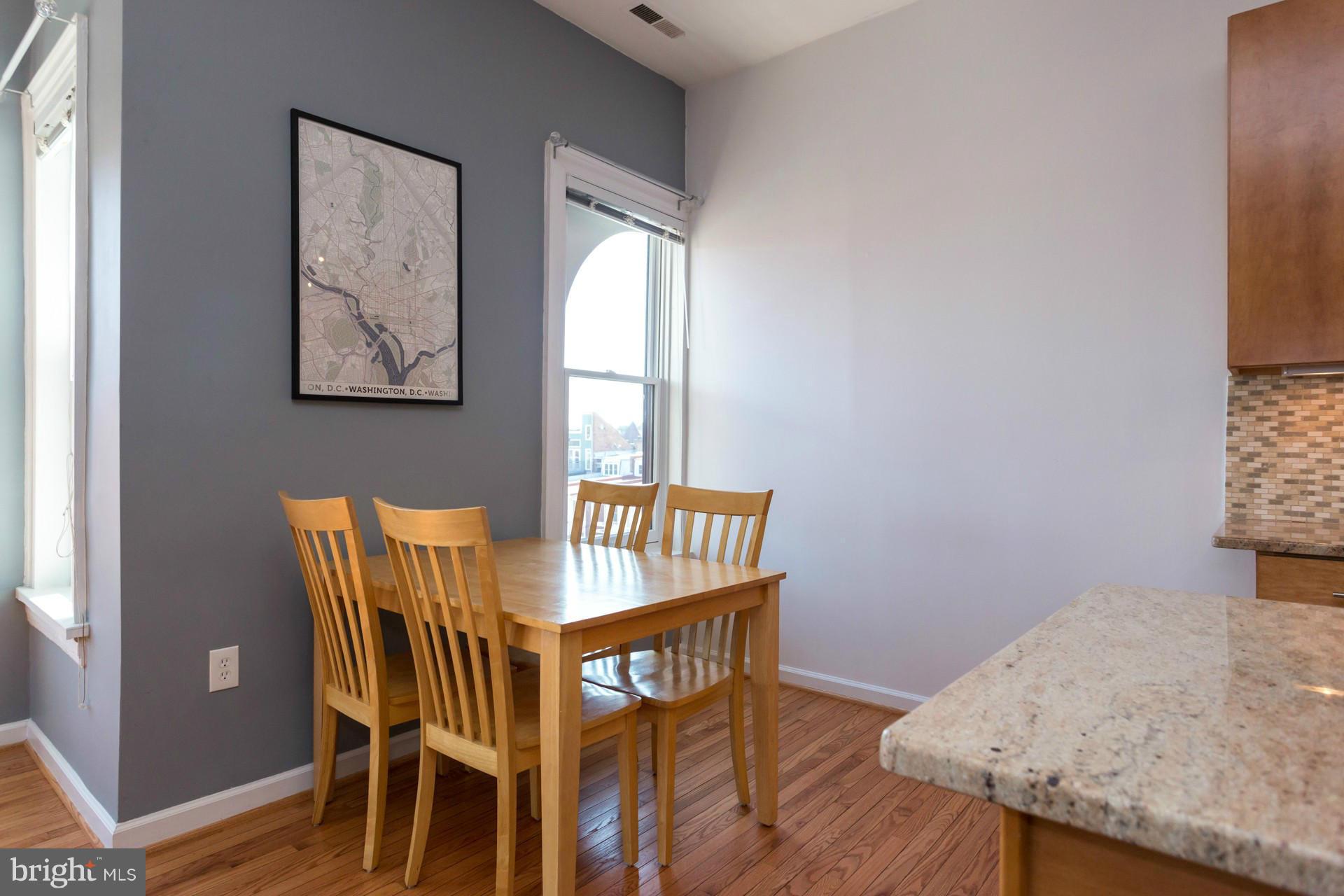1918 18th Street Northwest, Unit 41 Washington, DC 20009 - Photo 11 of 30 a view of a dining room with furniture and wooden floor