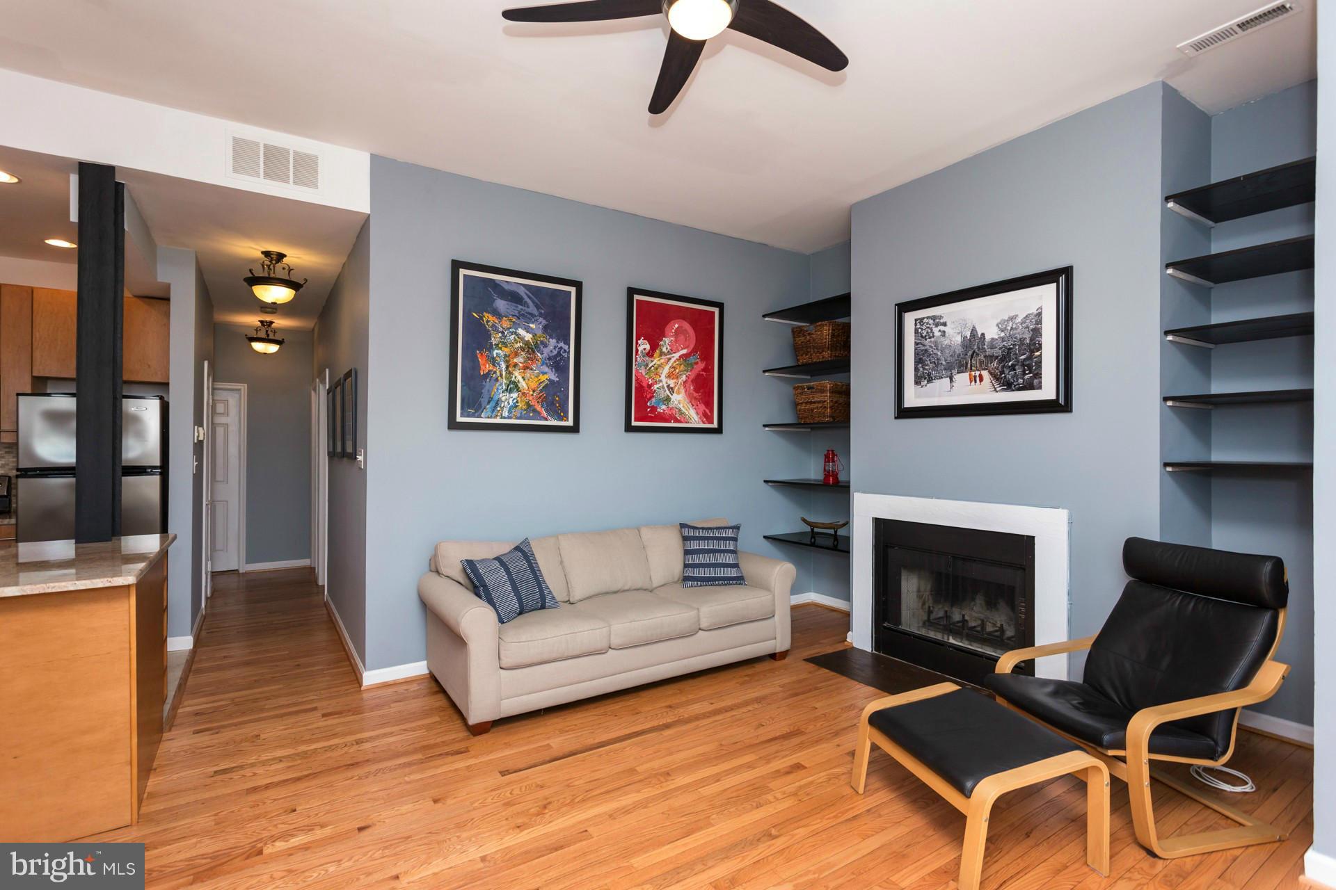1918 18th Street Northwest, Unit 41 Washington, DC 20009 - Photo 15 of 30 a living room with furniture a fireplace and wooden floor