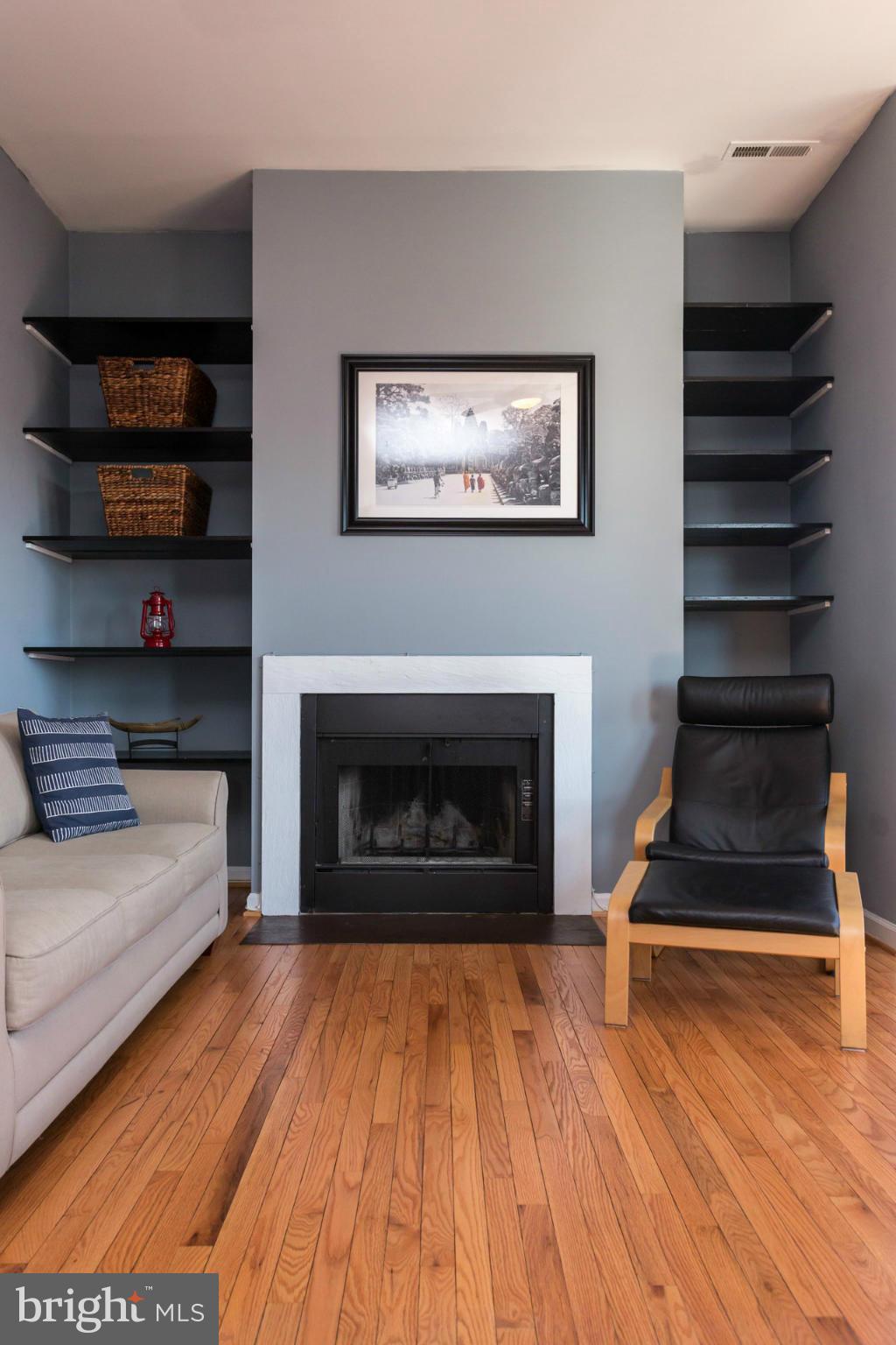 1918 18th Street Northwest, Unit 41 Washington, DC 20009 - Photo 18 of 30 a living room with hard wood floors and a fireplace