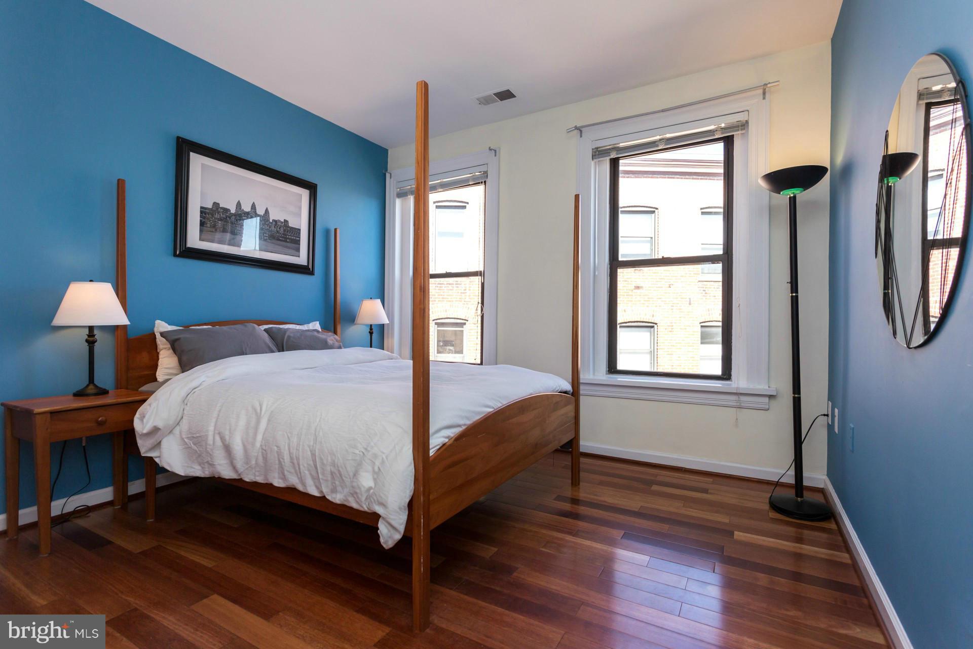 1918 18th Street Northwest, Unit 41 Washington, DC 20009 - Photo 19 of 30 a bed sitting in a bedroom next to a window