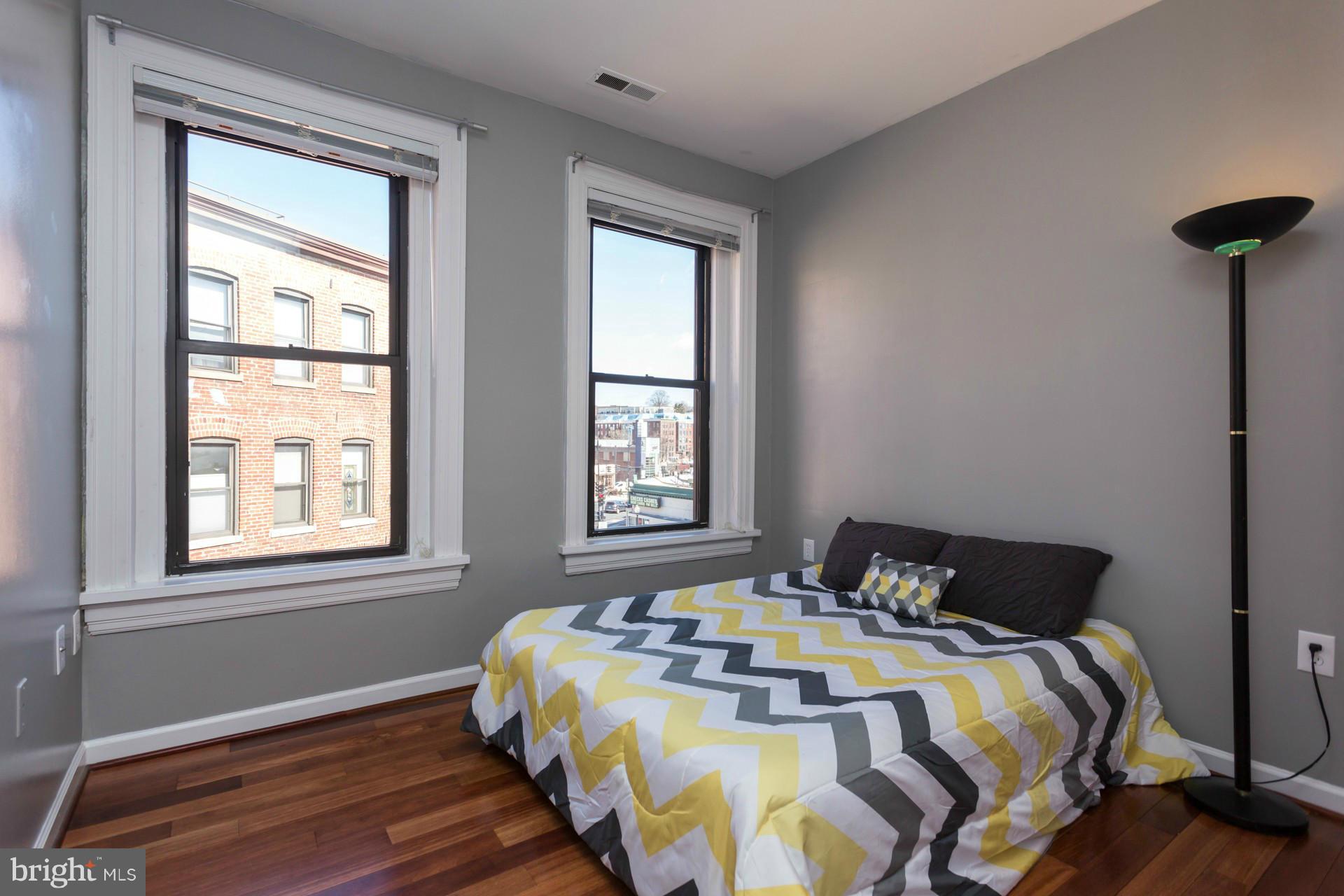 1918 18th Street Northwest, Unit 41 Washington, DC 20009 - Photo 21 of 30 a bedroom with a bed and a window