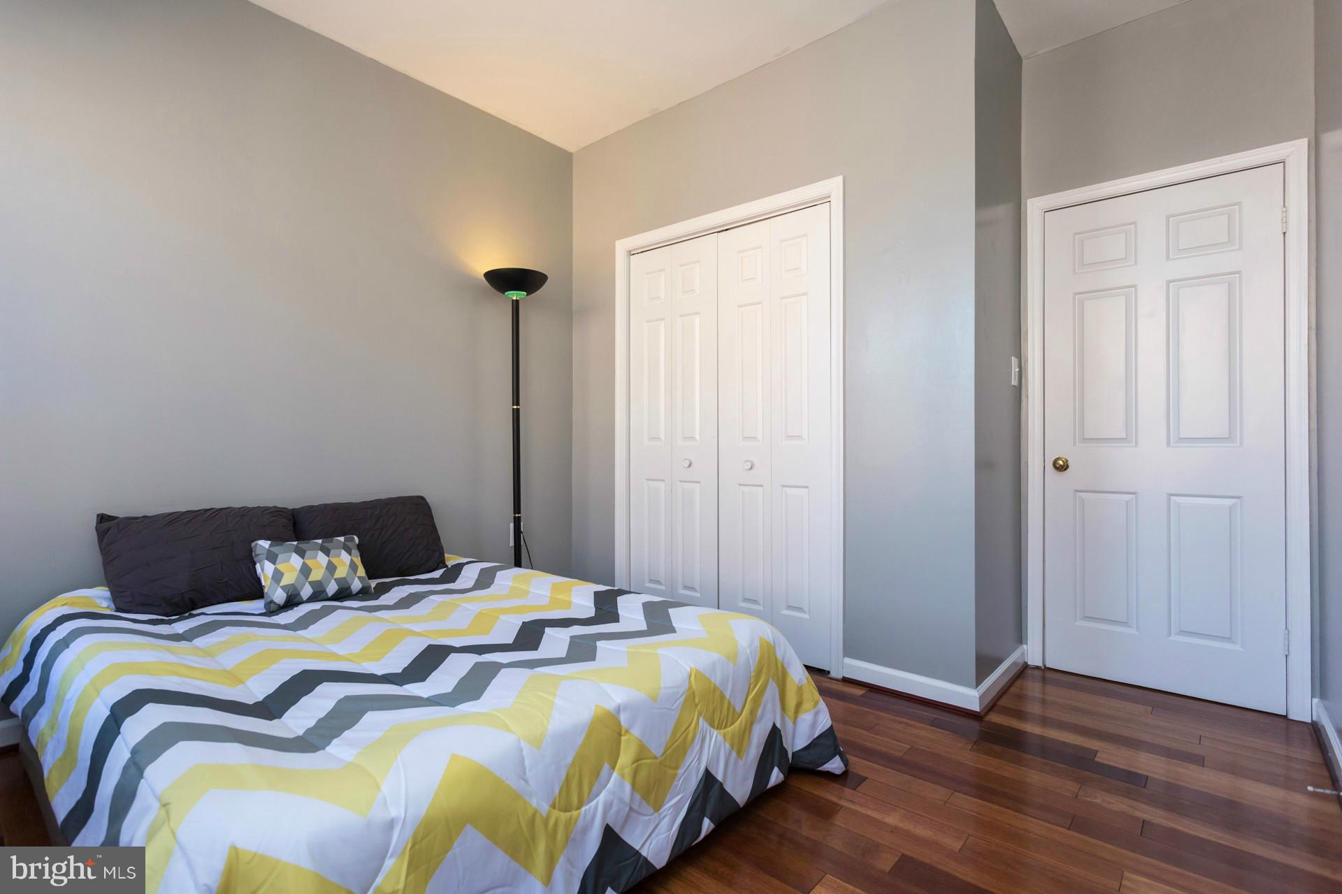 1918 18th Street Northwest, Unit 41 Washington, DC 20009 - Photo 22 of 30 a bedroom with a bed and wooden floor