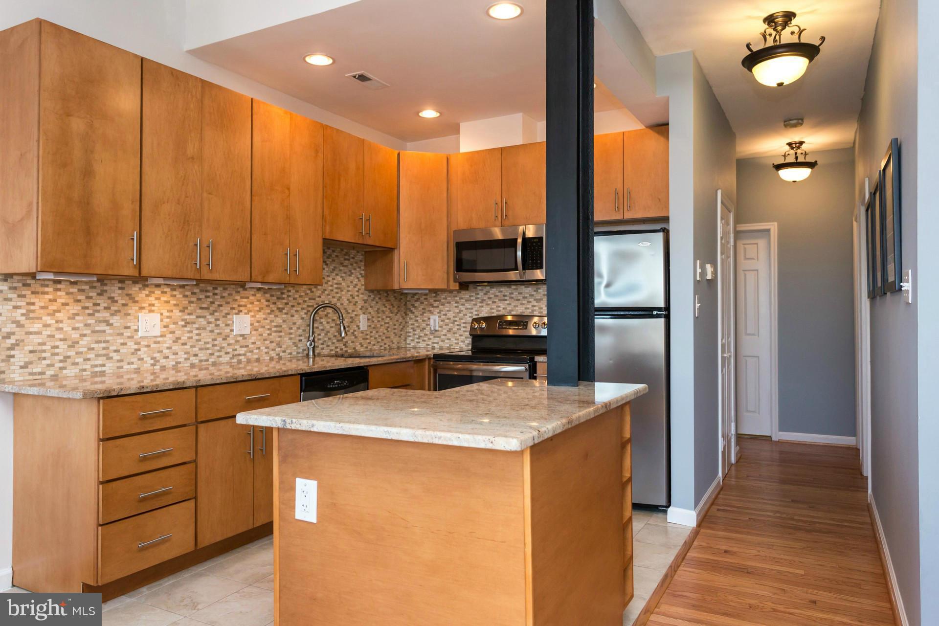 1918 18th Street Northwest, Unit 41 Washington, DC 20009 - Photo 6 of 30 a kitchen that has a sink and a stove in it