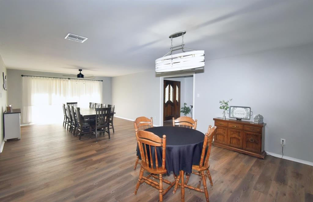 802 West Coke Road Winnsboro, TX 75494 - Photo 13 of 40 a view of a dining room with furniture and wooden floor