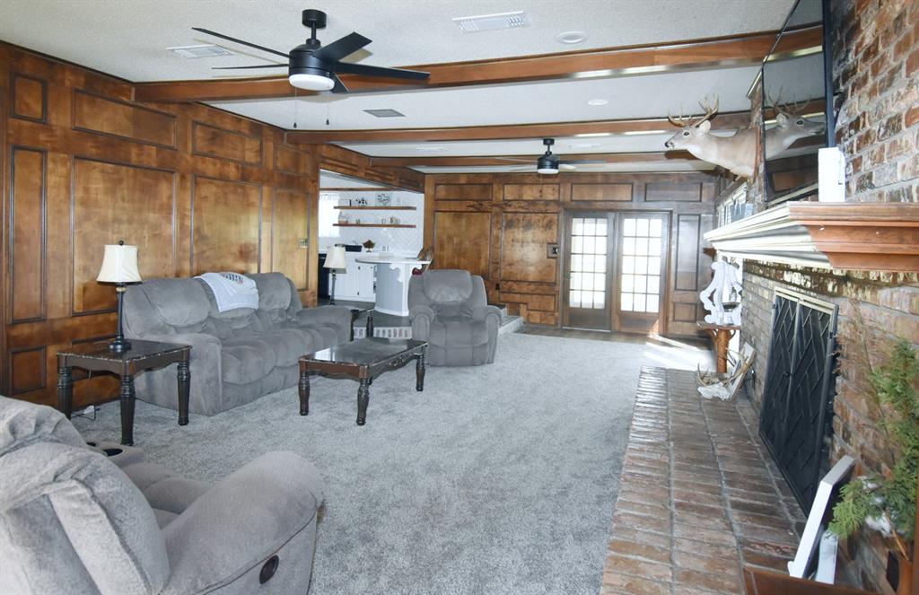 802 West Coke Road Winnsboro, TX 75494 - Photo 16 of 40 a living room with furniture and a fireplace
