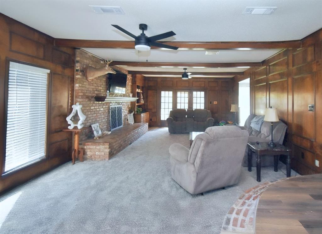 802 West Coke Road Winnsboro, TX 75494 - Photo 17 of 40 a living room with furniture and a chandelier