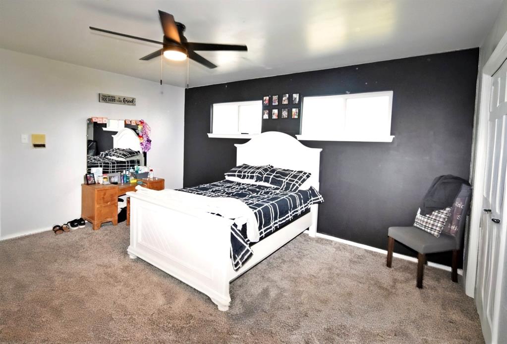 802 West Coke Road Winnsboro, TX 75494 - Photo 31 of 40 a bedroom with a bed and a chandelier