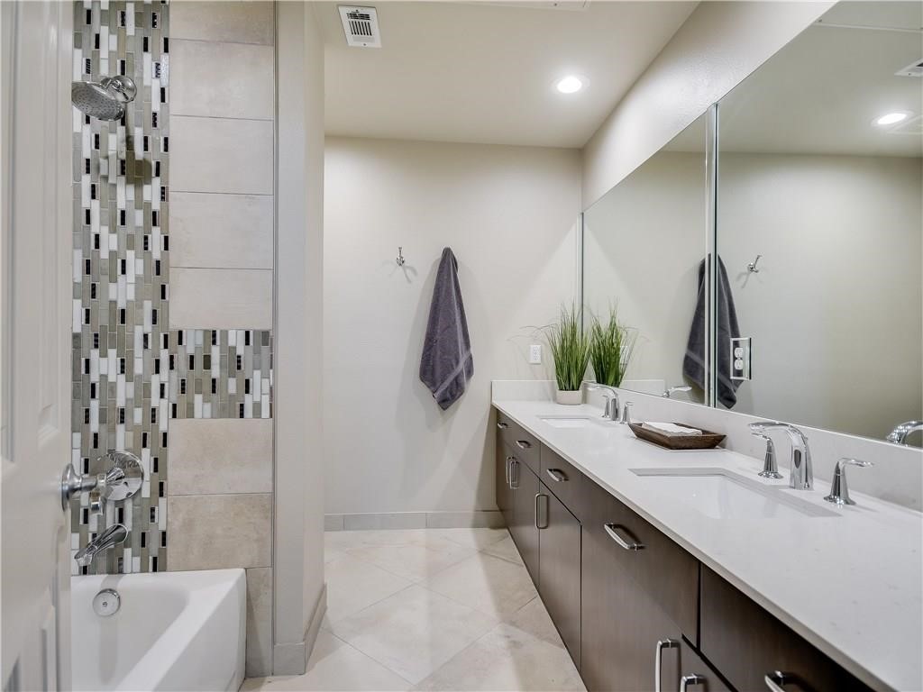 2918 Ranch Road 620 North, Unit W221 Austin, TX 78734 - Photo 12 of 20 a bathroom with a double vanity sink and mirror
