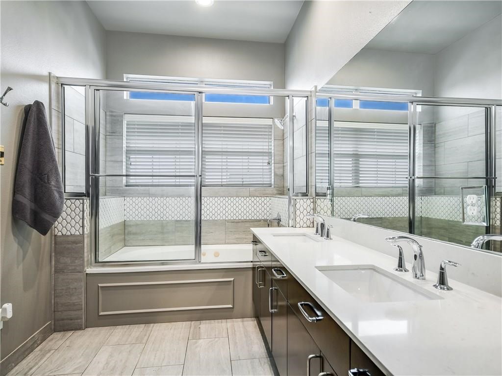 2918 Ranch Road 620 North, Unit W221 Austin, TX 78734 - Photo 10 of 20 a bathroom with a double vanity sink and mirror