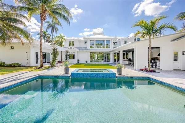 a swimming pool with outdoor seating and yard