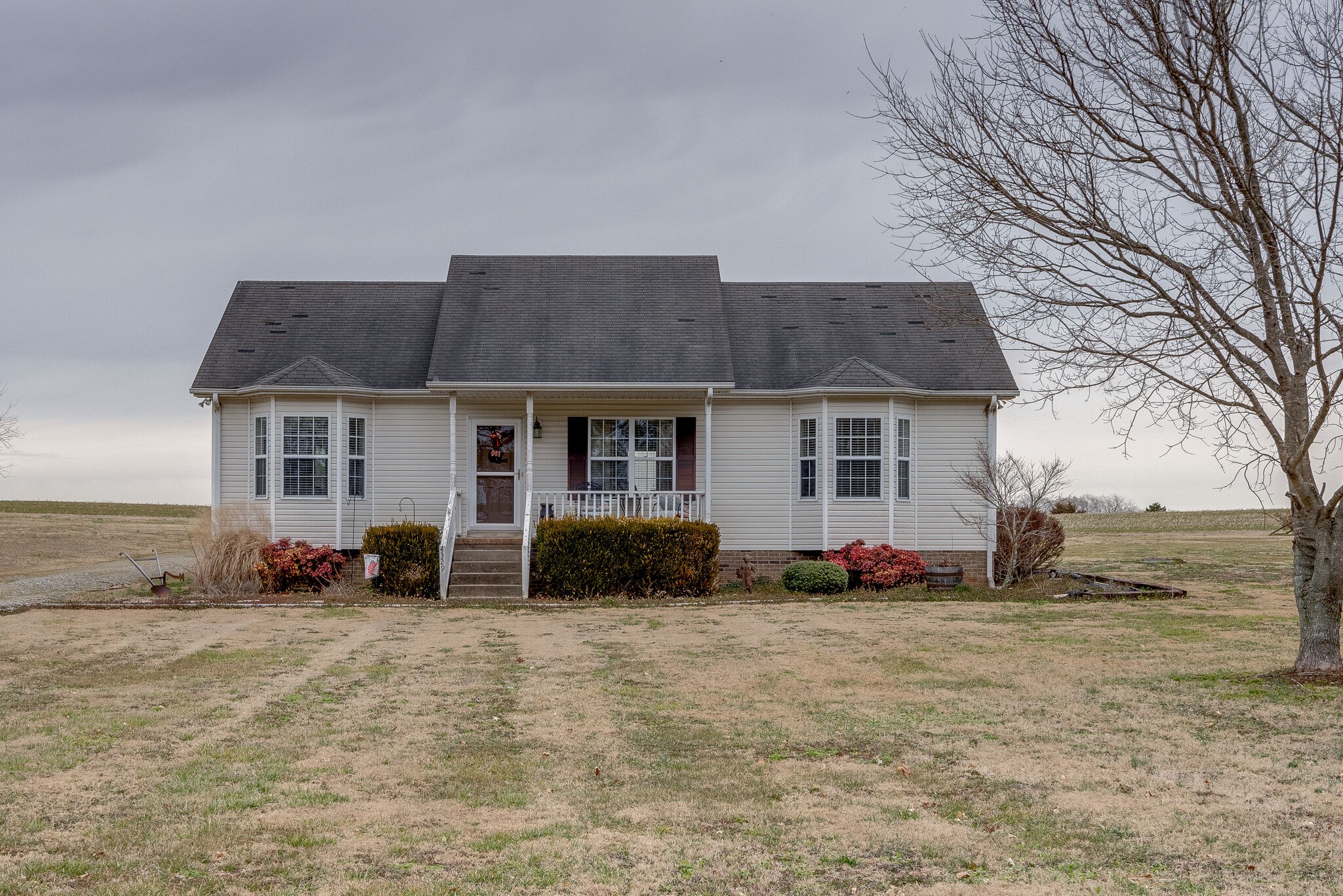 4329 Matthews Road Cedar Hill, TN 37032 - Photo 1 of 17 a front view of a house with a yard and seating space
