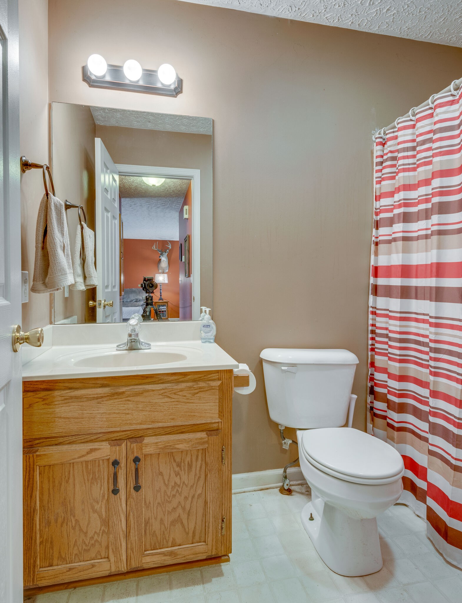 4329 Matthews Road Cedar Hill, TN 37032 - Photo 12 of 17 a bathroom with a granite countertop toilet a sink and a mirror