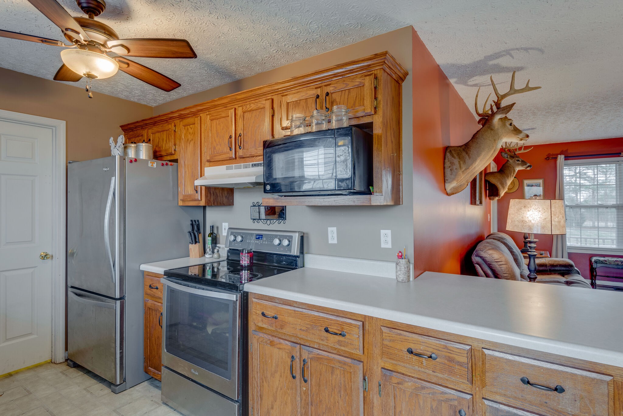 4329 Matthews Road Cedar Hill, TN 37032 - Photo 6 of 17 a kitchen with stainless steel appliances granite countertop a sink a refrigerator and cabinets
