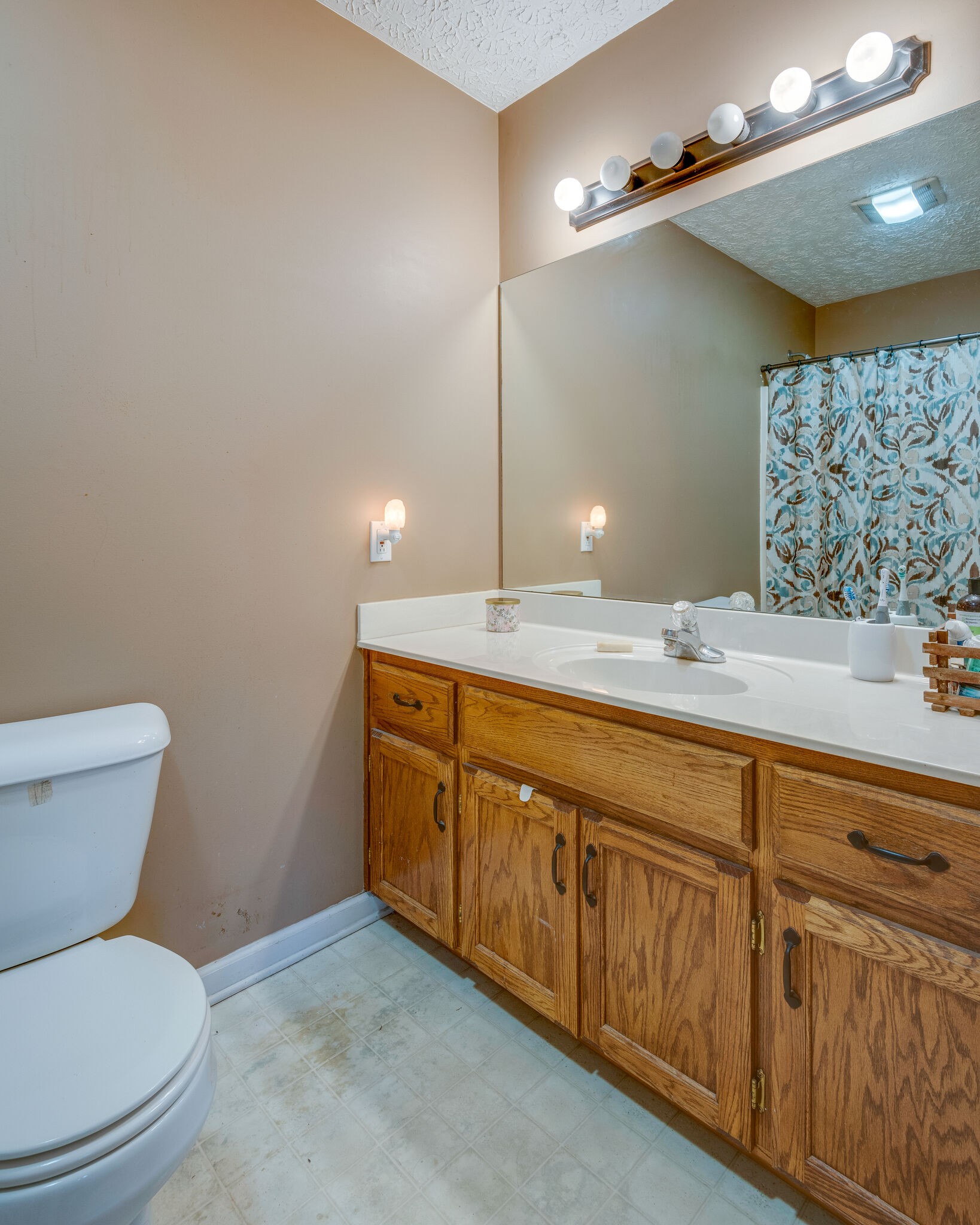 4329 Matthews Road Cedar Hill, TN 37032 - Photo 9 of 17 a bathroom with a granite countertop toilet sink and mirror