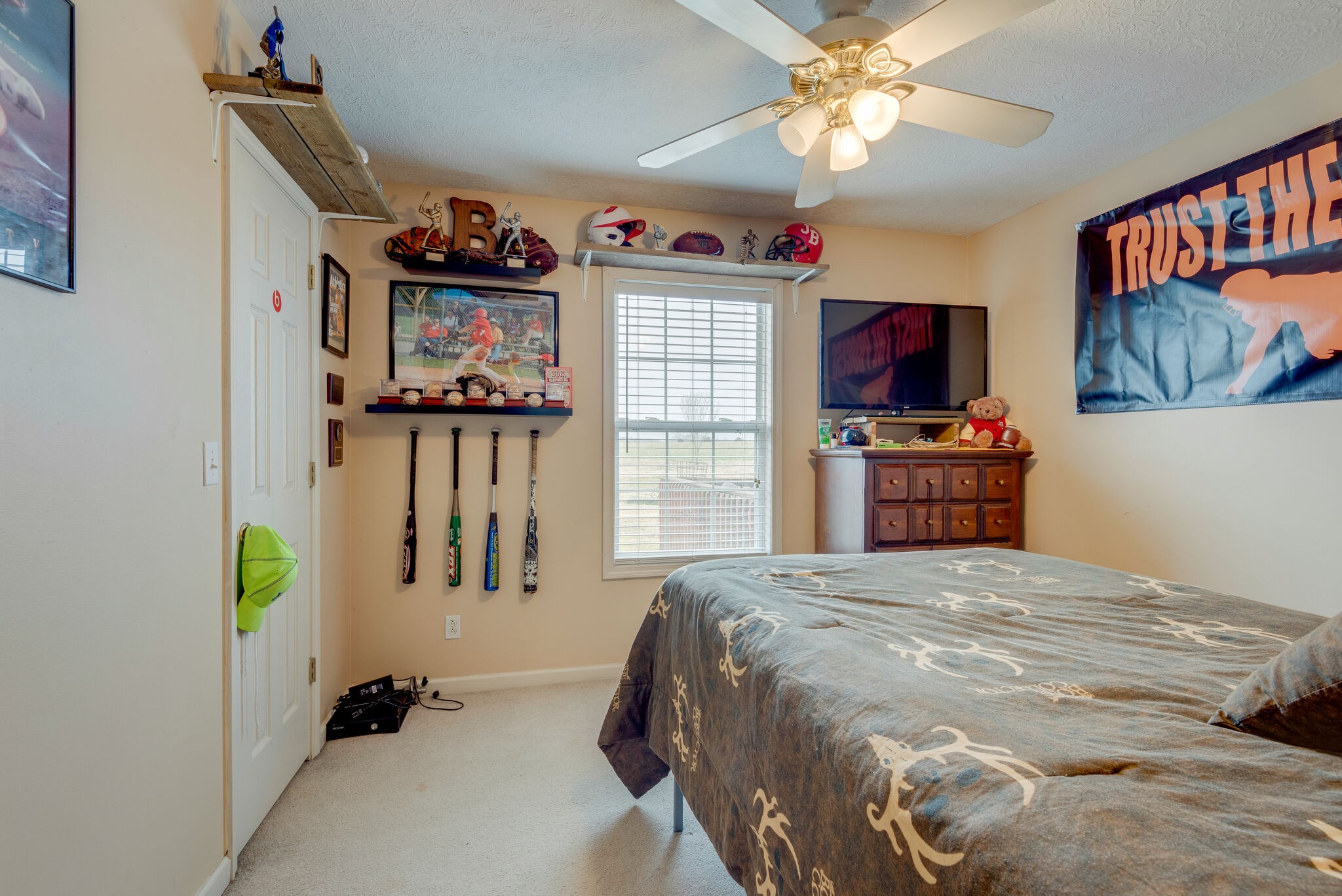 4329 Matthews Road Cedar Hill, TN 37032 - Photo 10 of 17 a bedroom with a bed a computer on a desk and a book shelf