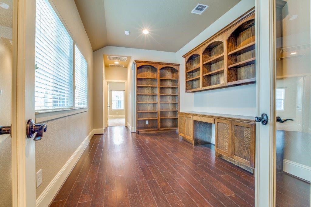 46 East Rafters Row The Woodlands, TX 77380 - Photo 12 of 25 Executive study with custom built-in cabinetry and shelving—ideal for working from home or a library.