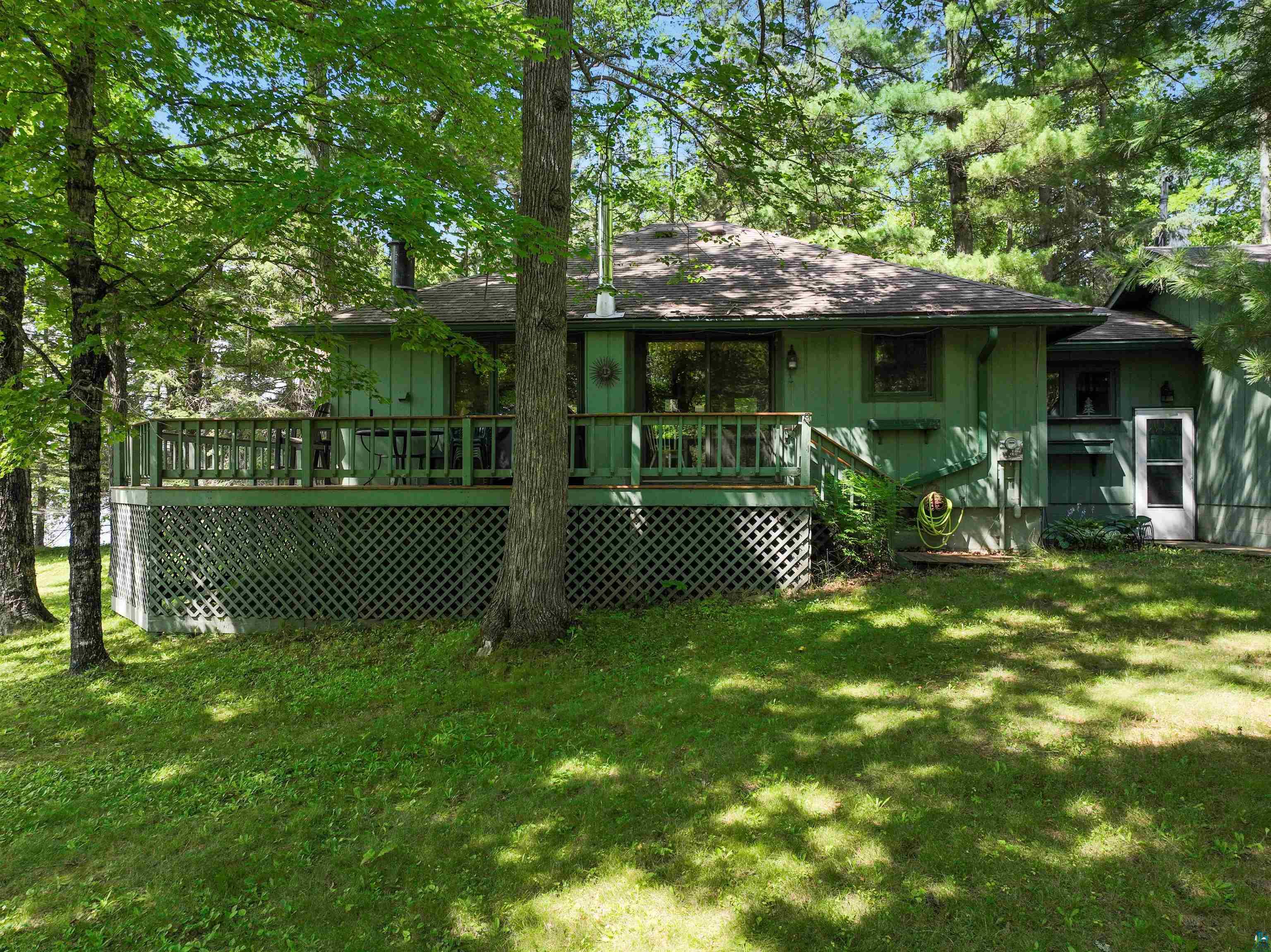 Back of house with a yard and a deck