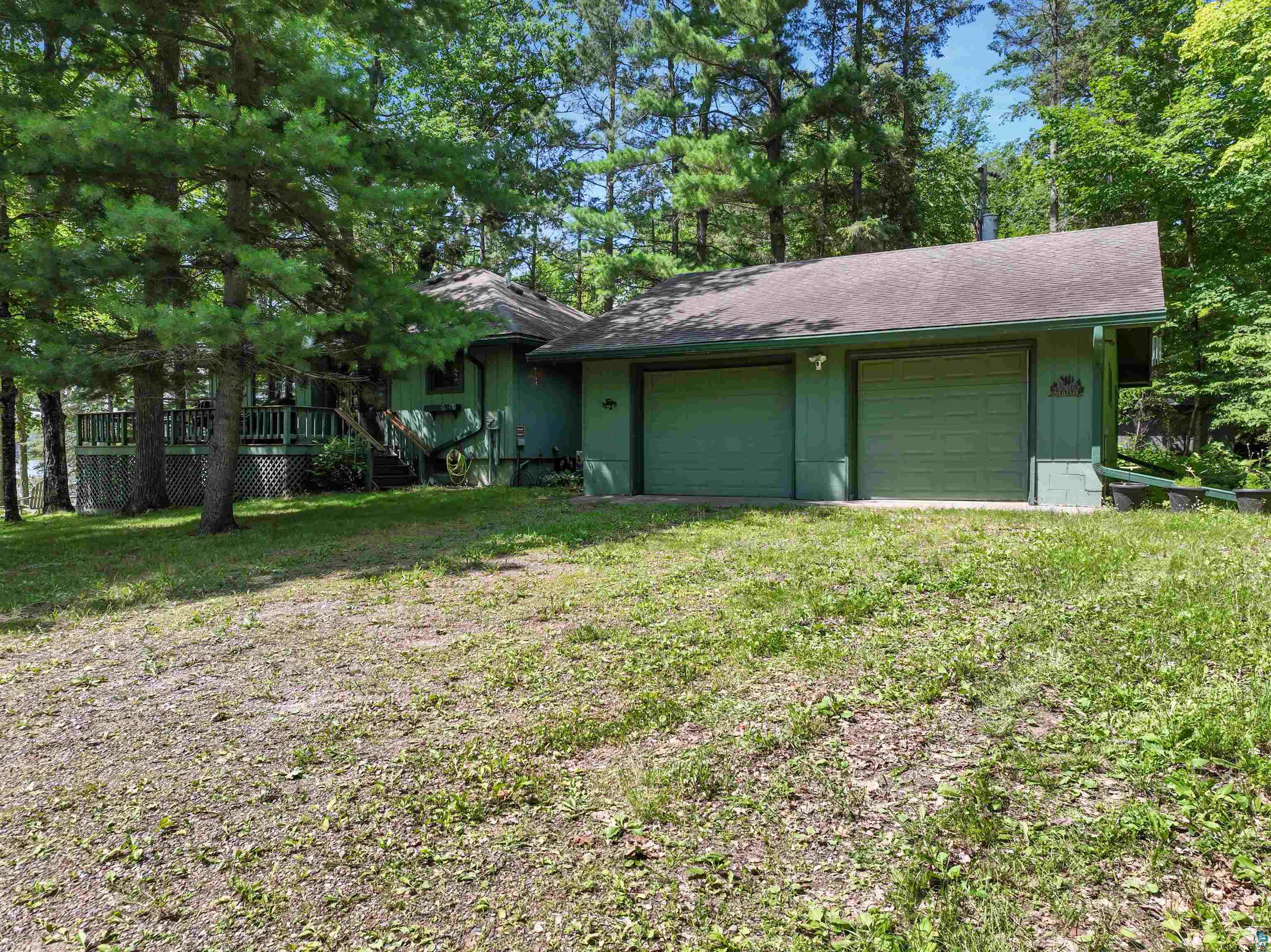 View of front facade featuring a garage and a front lawn