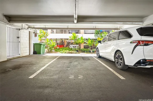 a view of parking garage with cars parked