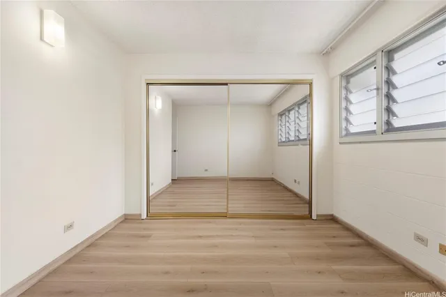 a view of a livingroom with wooden floor and window