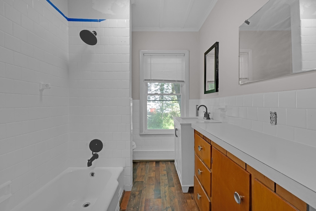 47 Morris Street Southbridge, MA 01550 - Photo 5 of 40 a bathroom with a bathtub sink and mirror