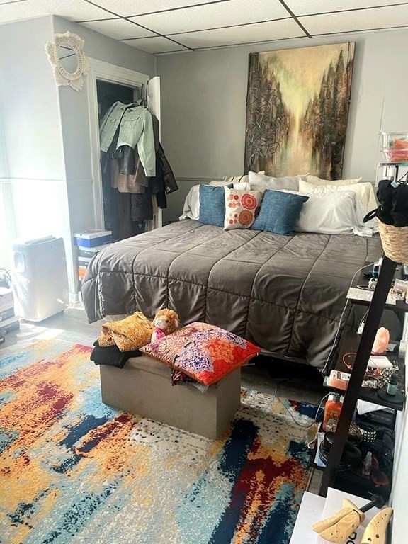 317 Nesmith Street Lowell, MA 01852 - Photo 12 of 16 a bedroom with a bed and a mirror