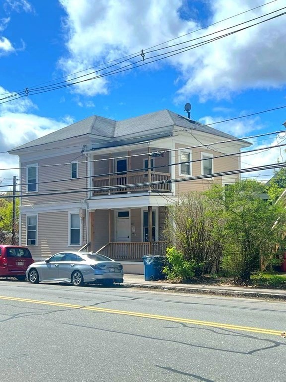 317 Nesmith Street Lowell, MA 01852 - Photo 2 of 16 a front view of a house with a garden