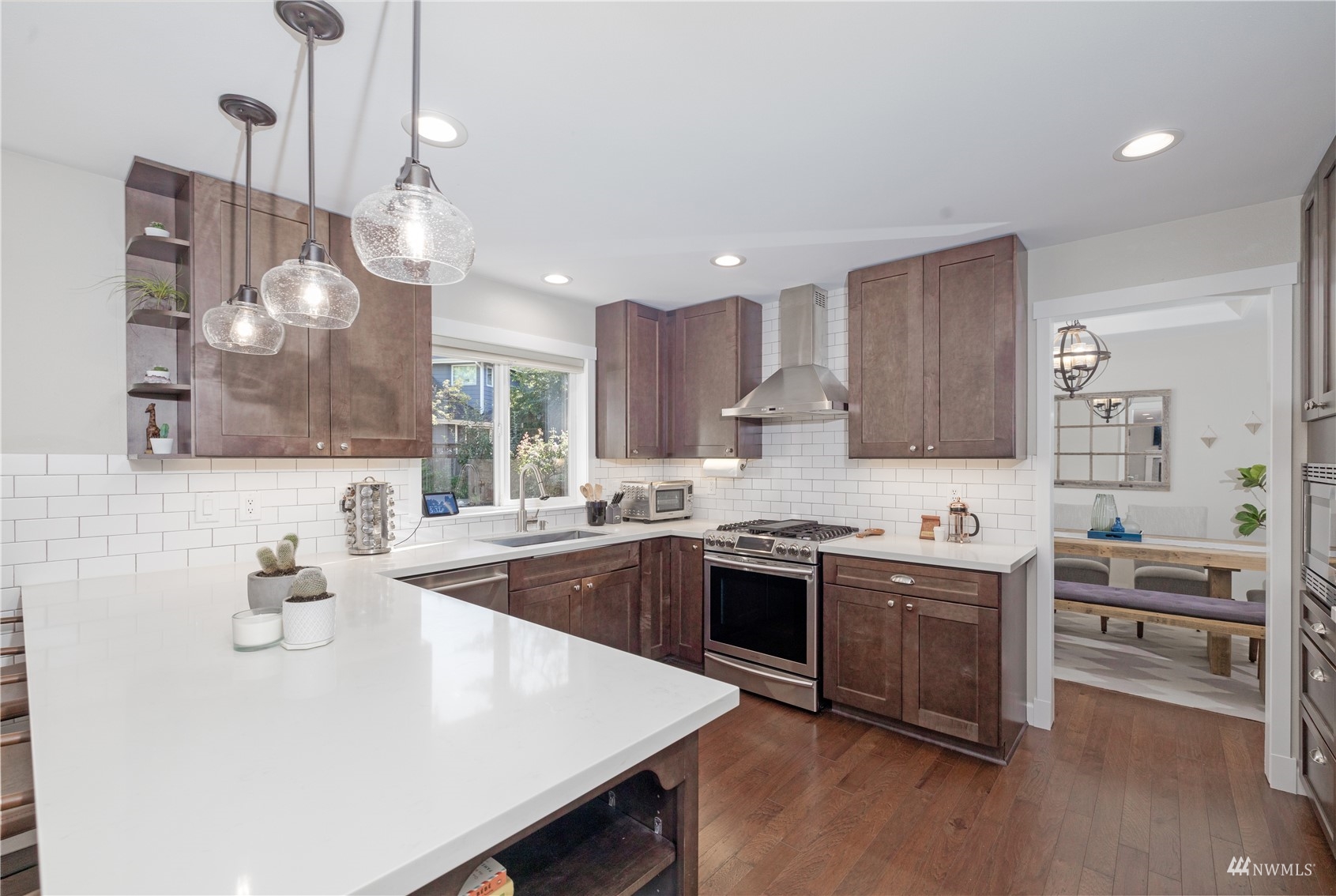 9419 Northeast 175th Street Bothell, WA 98011 - Photo 13 of 28 a kitchen with a stove a sink and a refrigerator