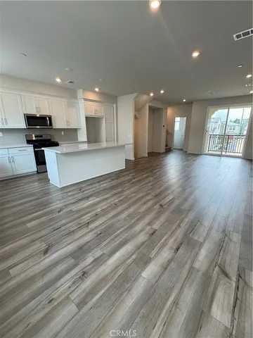 a view of kitchen with refrigerator and window