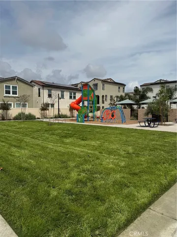 a view of a house with a big yard and large trees