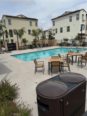 a swimming pool with outdoor seating and yard