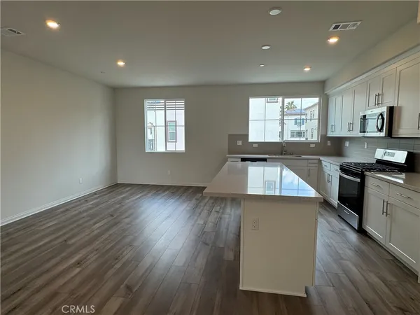 a view of a kitchen with sink and wooden floor