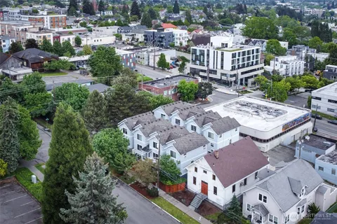 an aerial view of multiple houses with yard