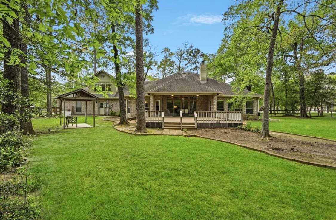 a swimming pool with outdoor seating and yard