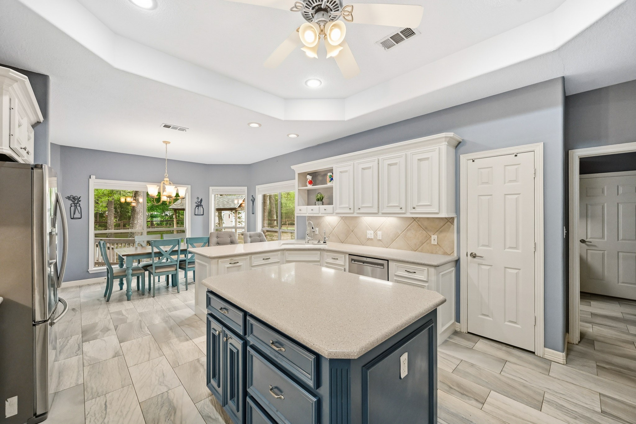 11995 White Oak Crossing Conroe, TX 77385 - Photo 14 of 44 a kitchen with a stove a refrigerator a sink dishwasher with a dining table and chairs with wooden floor