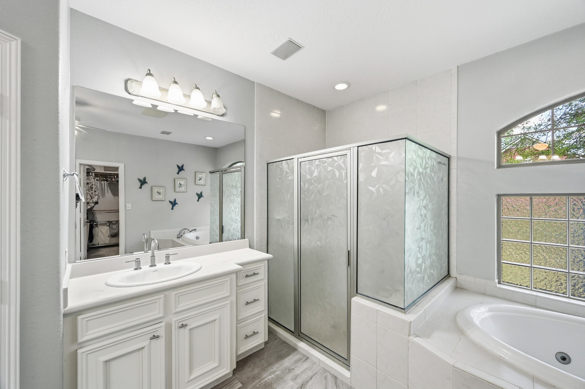 11995 White Oak Crossing Conroe, TX 77385 - Photo 19 of 44 a bathroom with a double vanity sink mirror bathtub and shower
