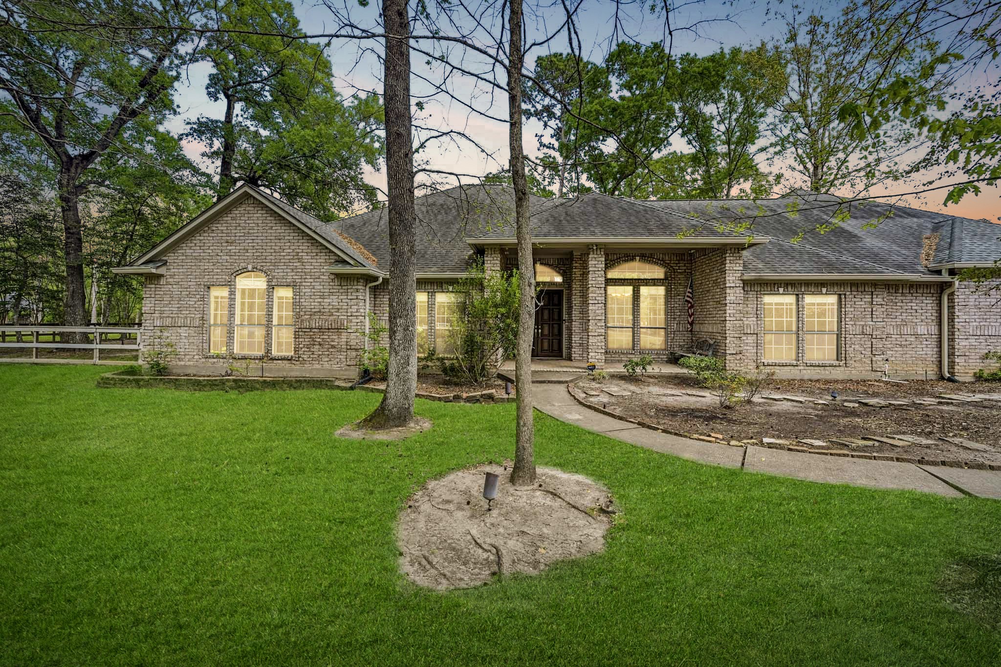 11995 White Oak Crossing Conroe, TX 77385 - Photo 2 of 44 a front view of a house with a yard and green space
