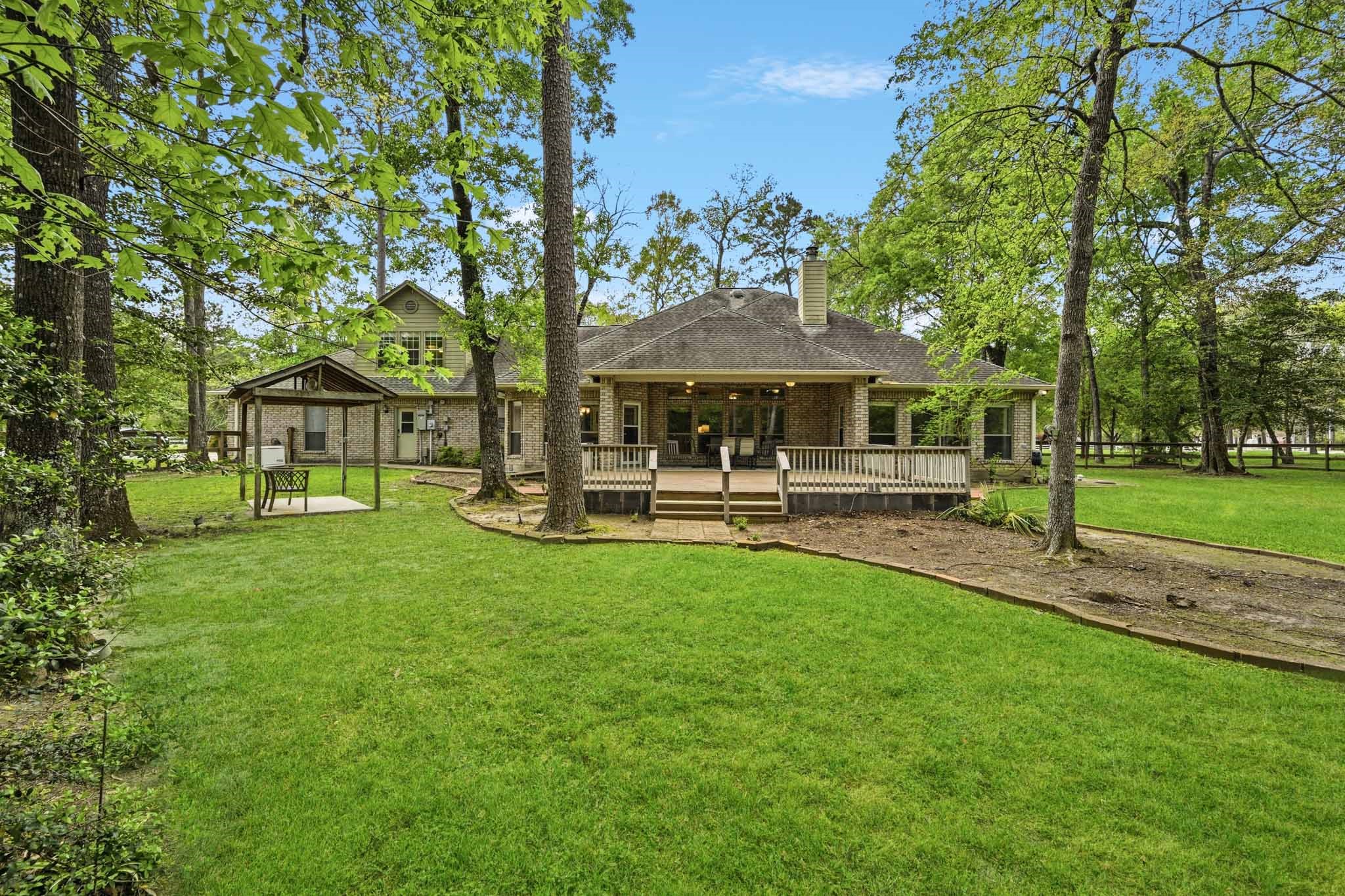 11995 White Oak Crossing Conroe, TX 77385 - Photo 32 of 44 a swimming pool with outdoor seating and yard