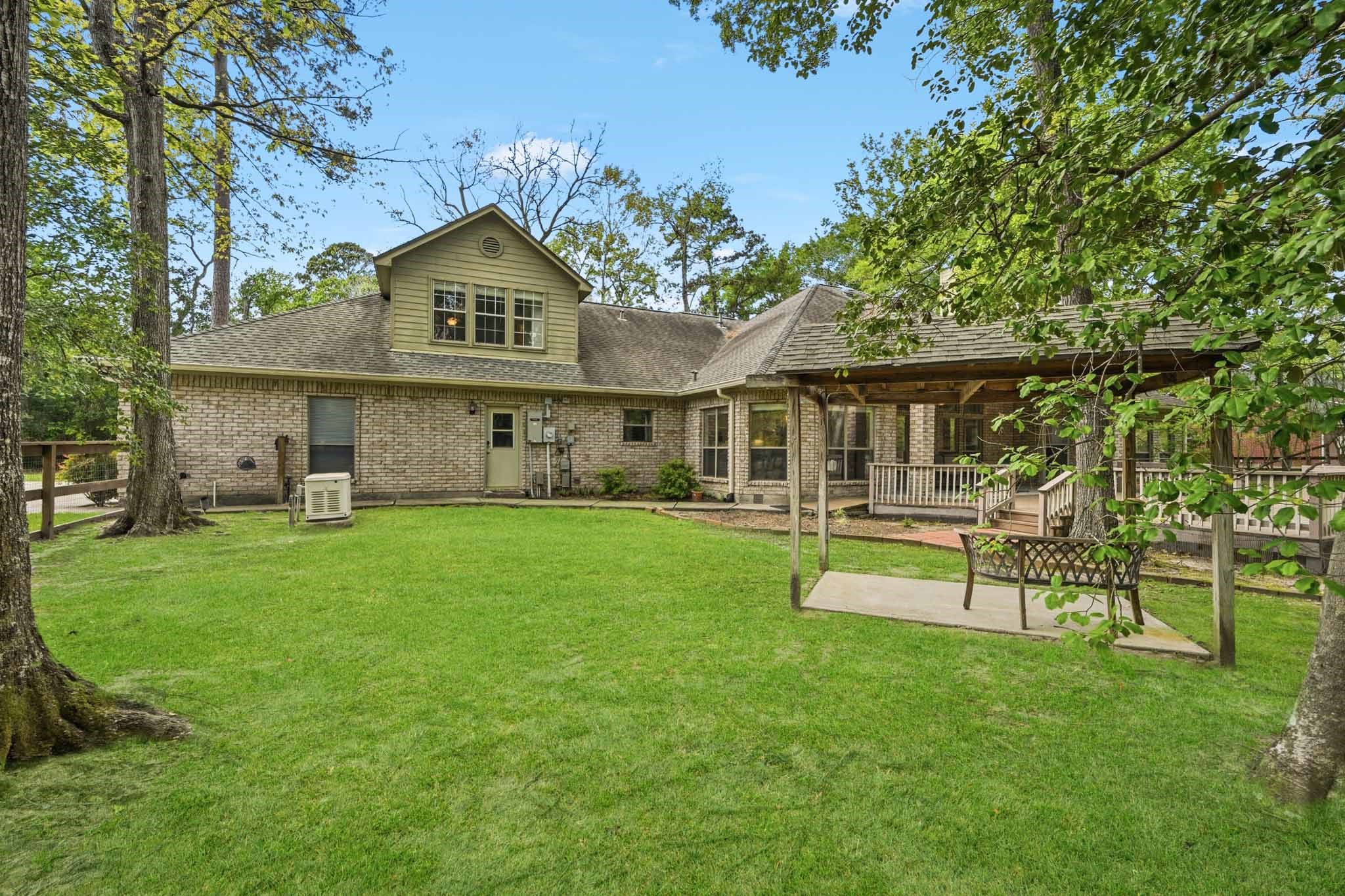 11995 White Oak Crossing Conroe, TX 77385 - Photo 33 of 44 a view of a house with a yard