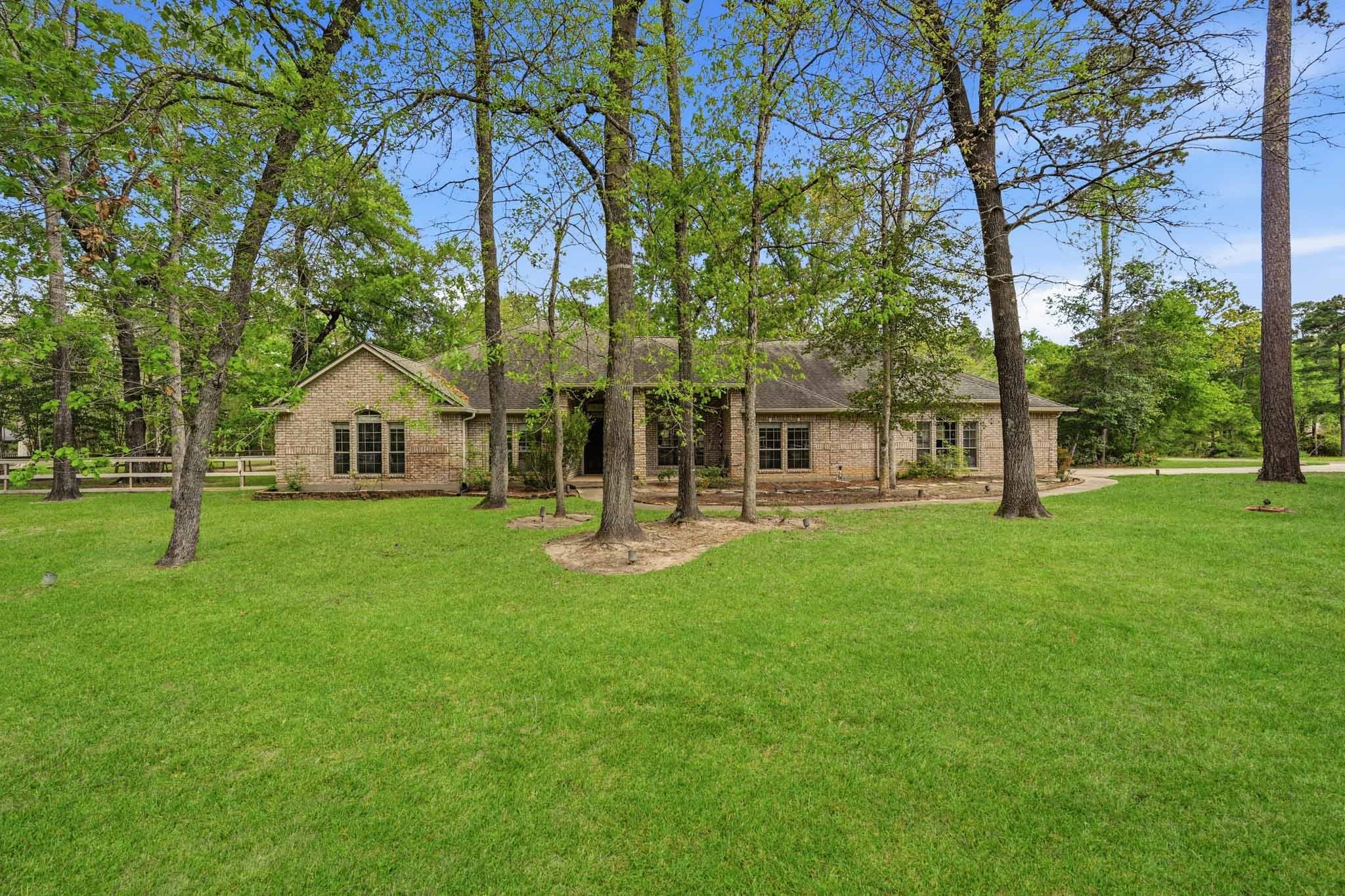 11995 White Oak Crossing Conroe, TX 77385 - Photo 34 of 44 a view of a house with backyard and a tree