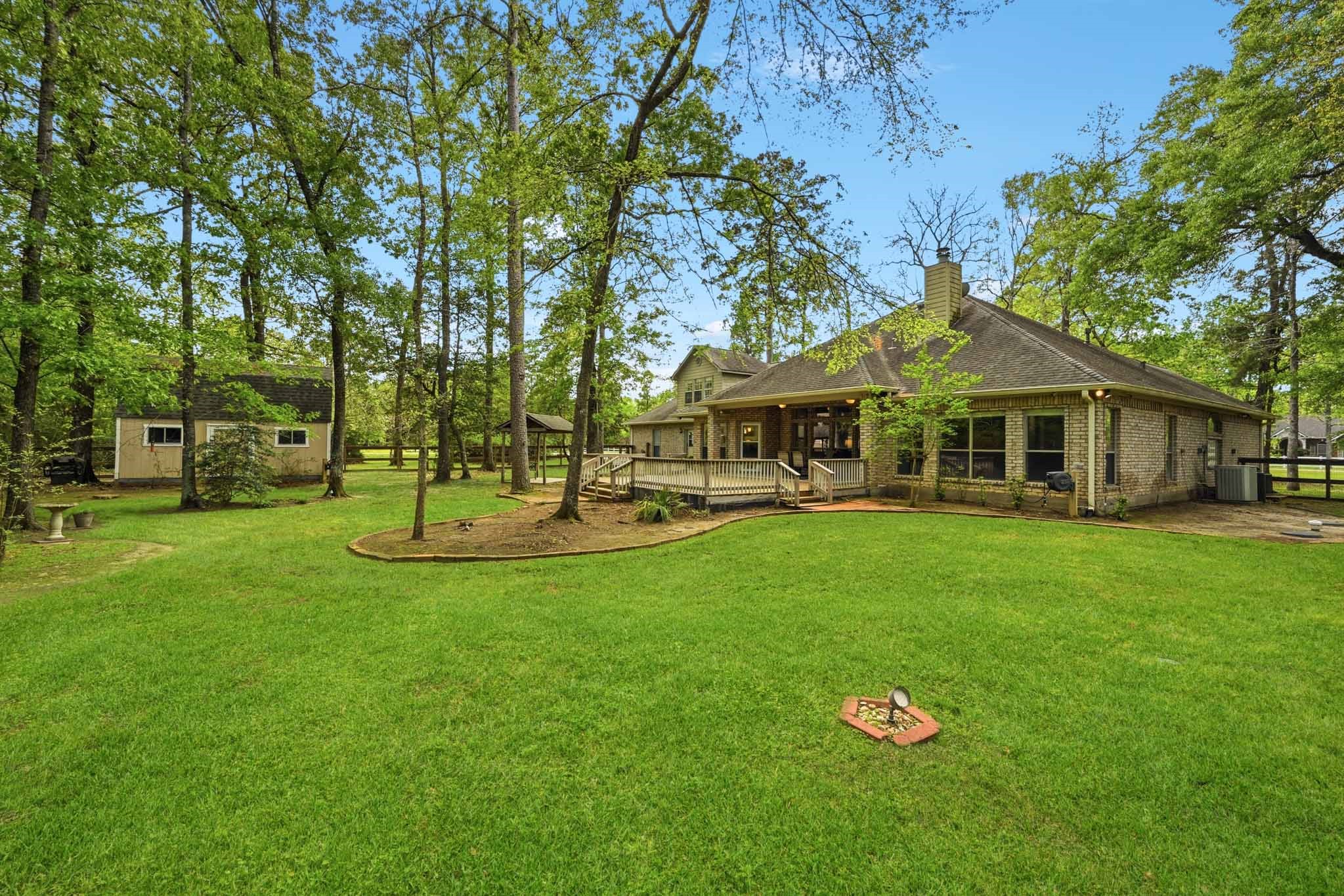 11995 White Oak Crossing Conroe, TX 77385 - Photo 43 of 44 a view of a house with a yard