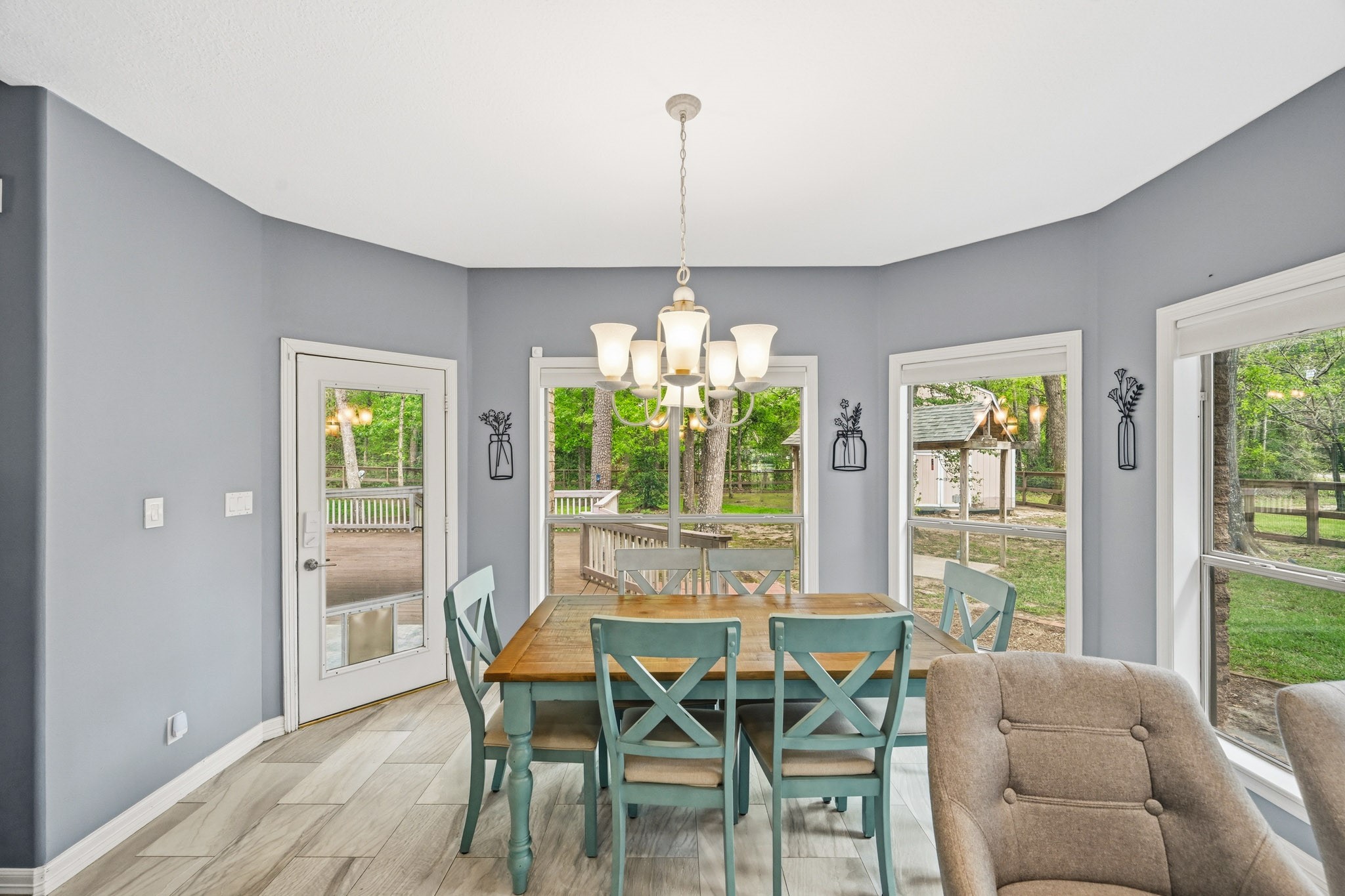 11995 White Oak Crossing Conroe, TX 77385 - Photo 10 of 44 a dining room with furniture a chandelier and wooden floor
