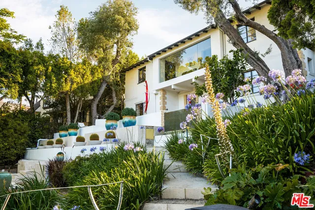 a view of a house with backyard and sitting area
