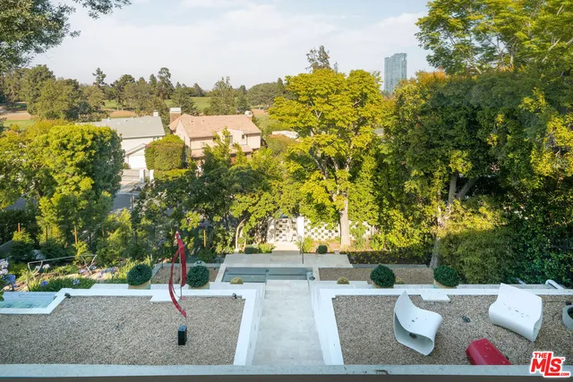 swimming pool view with a seating space and a garden