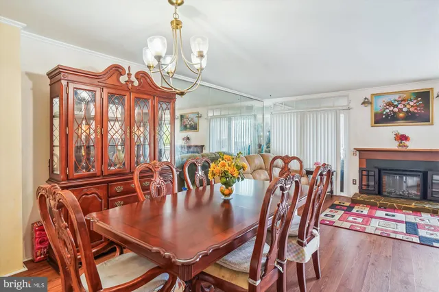 a view of a a dining room with furniture window and wooden floor