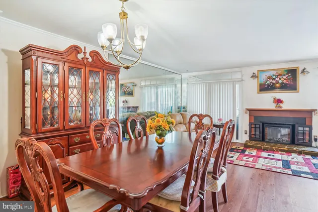 a view of a dining room with furniture wooden floor and chandelier